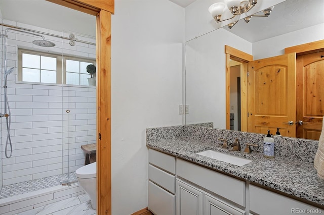 14370 Osage St, Westminster, CO 80023 - full bathroom featuring vanity, a shower stall, toilet, a chandelier, and marble finish flooring