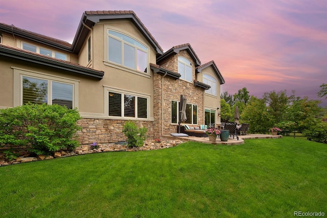 14370 Osage St, Westminster, CO 80023 - rear view of property with stone siding, stucco siding, a patio, and outdoor lounge area