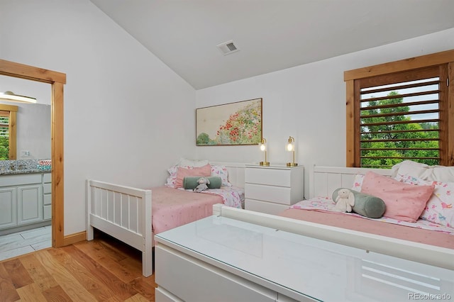 14370 Osage St, Westminster, CO 80023 - bedroom with lofted ceiling, light wood finished floors, and ensuite bath