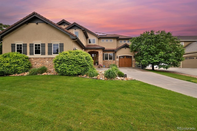 14370 Osage St, Westminster, CO 80023 - view of front of house featuring stone siding, stucco siding, a lawn, and driveway