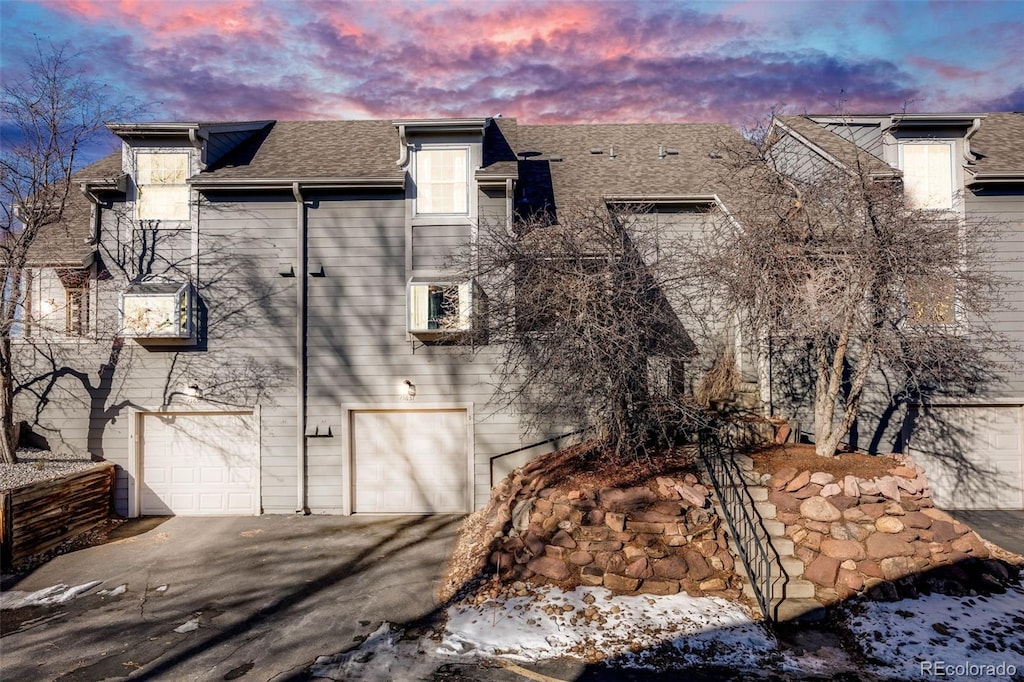 view of snowy exterior featuring a garage