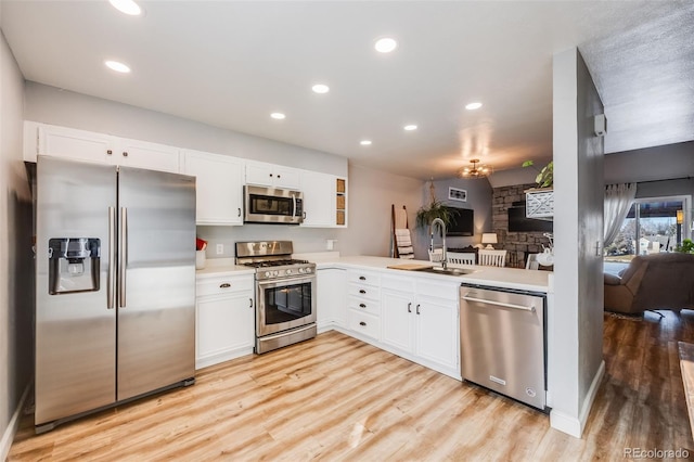 kitchen with white cabinets, appliances with stainless steel finishes, and sink