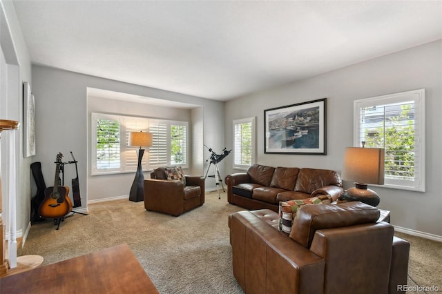 carpeted living room with plenty of natural light and baseboards