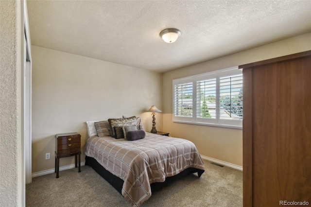 bedroom with carpet flooring, visible vents, and baseboards