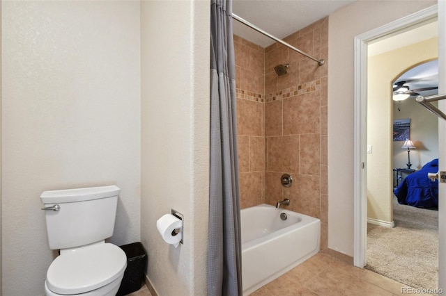 ensuite bathroom featuring ensuite bathroom, tile patterned flooring, toilet, baseboards, and shower / bathtub combination with curtain