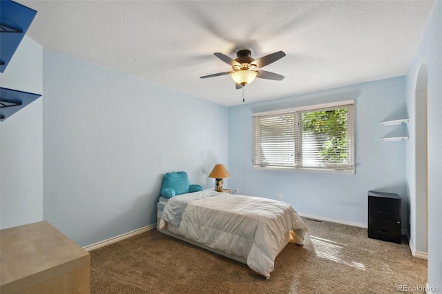 carpeted bedroom featuring ceiling fan and baseboards