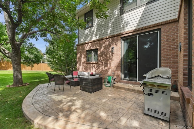 view of patio / terrace with area for grilling, fence, and an outdoor living space