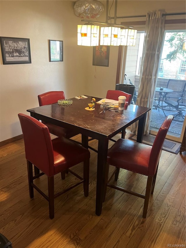 dining room featuring wood finished floors and baseboards