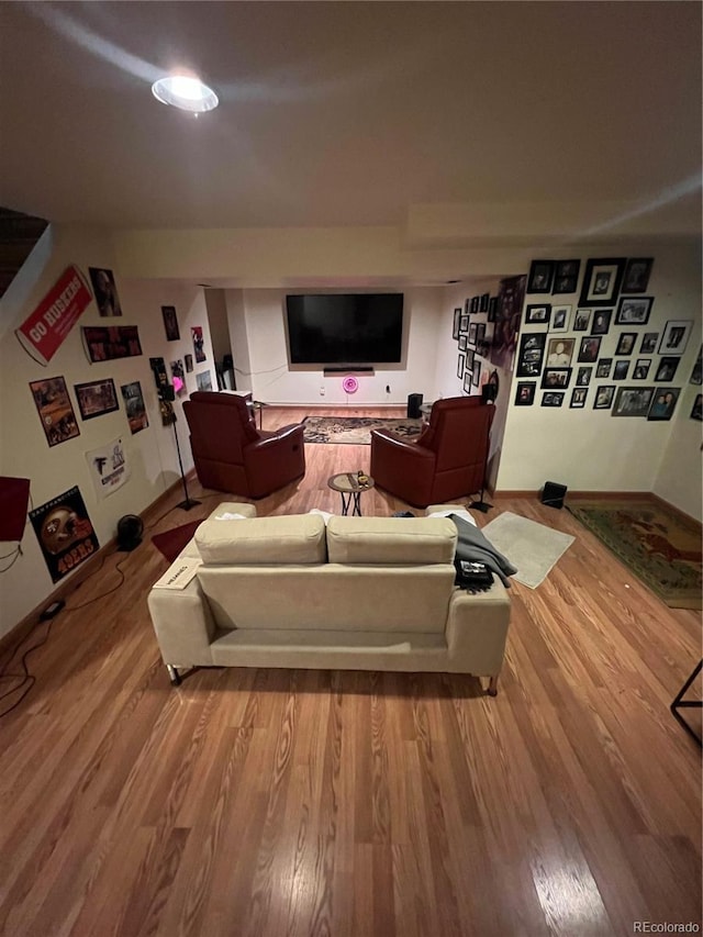 living room featuring wood finished floors and baseboards