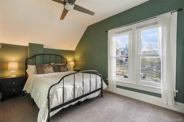 carpeted bedroom featuring a ceiling fan and vaulted ceiling