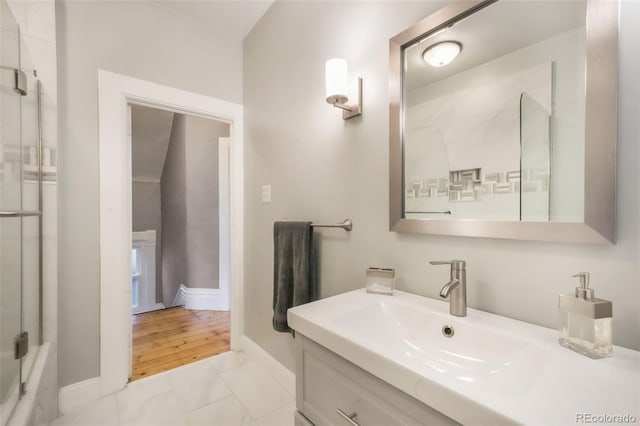 bathroom with vanity, baseboards, and marble finish floor