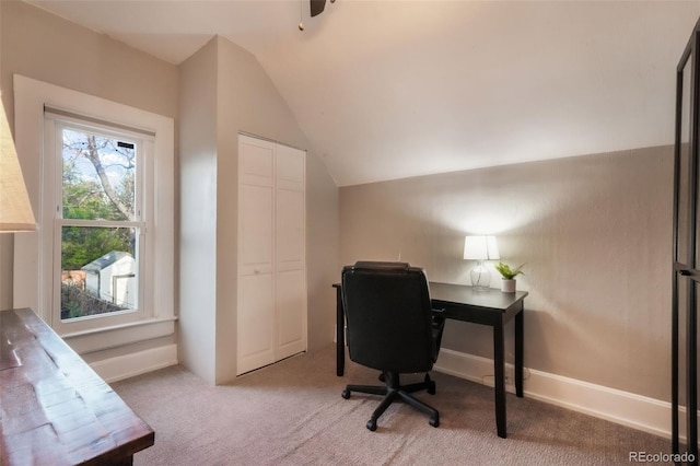 home office with light colored carpet and lofted ceiling