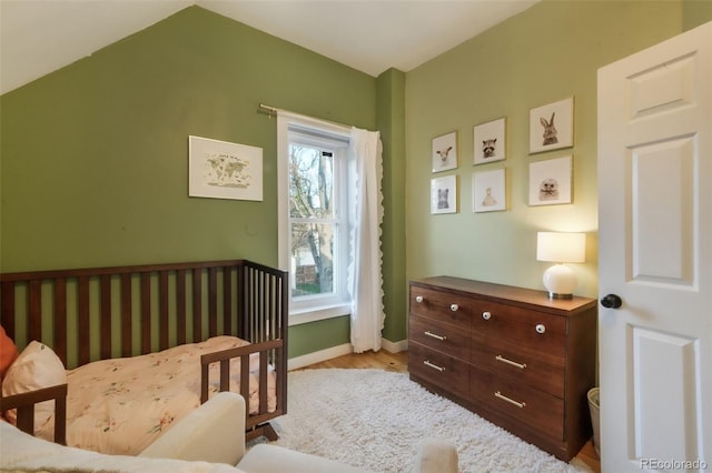bedroom featuring baseboards and wood finished floors