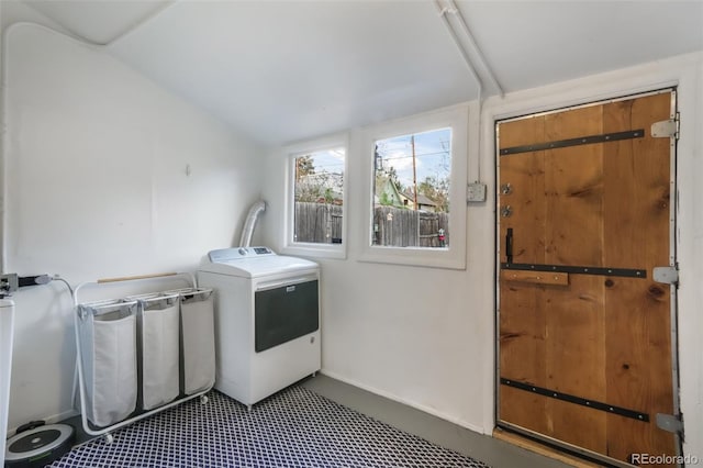 laundry room featuring baseboards, laundry area, and washer / clothes dryer