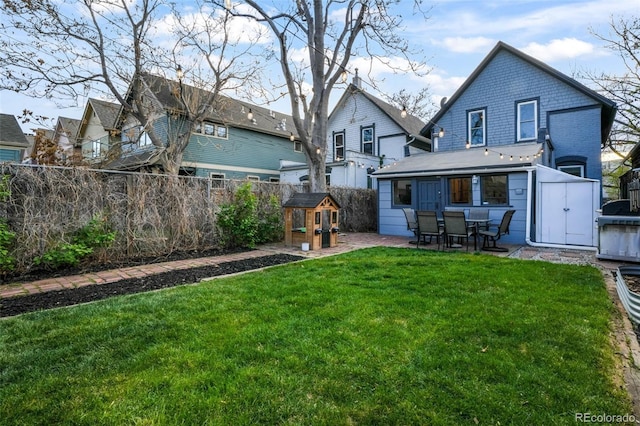 back of property featuring a yard, a patio, and a fenced backyard