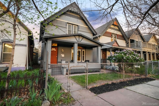 view of front of home with a gate, a fenced front yard, and covered porch