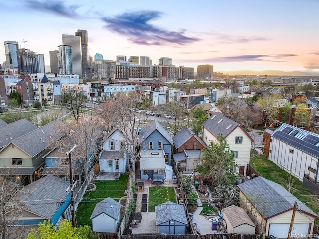 aerial view at dusk featuring a residential view