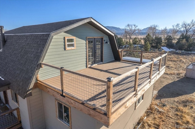 view of home's exterior featuring a balcony and a mountain view