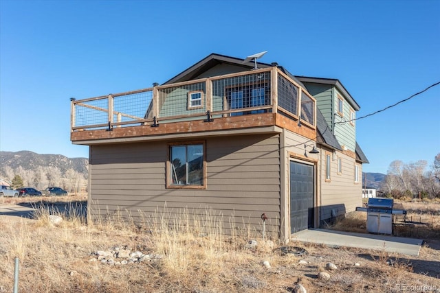 view of home's exterior featuring a garage and a mountain view