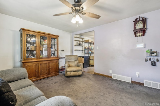 living room with ceiling fan and dark carpet