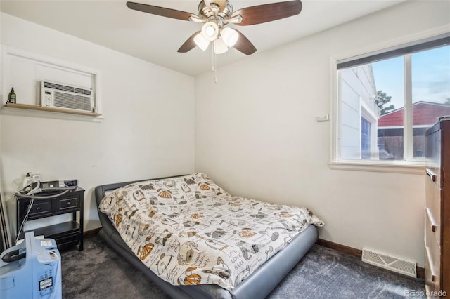 bedroom featuring dark carpet, ceiling fan, and an AC wall unit