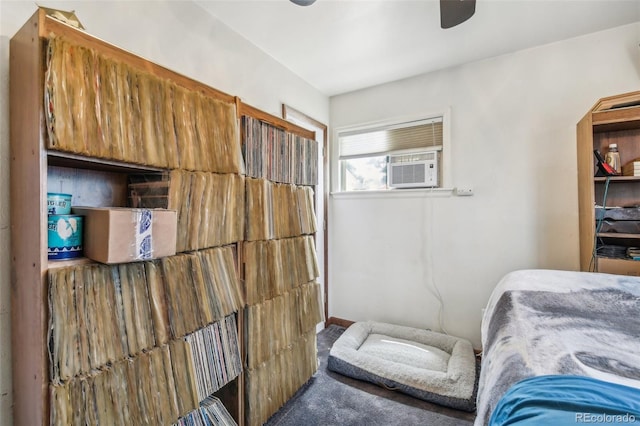 bedroom with ceiling fan, cooling unit, and carpet floors