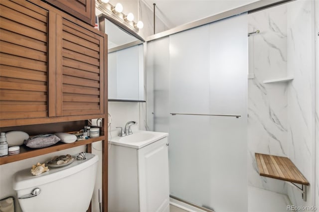 bathroom with vanity, an enclosed shower, and toilet