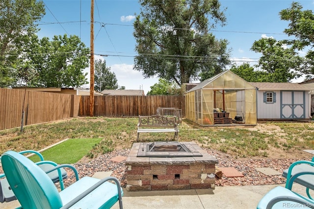 view of yard with a fire pit and an outdoor structure