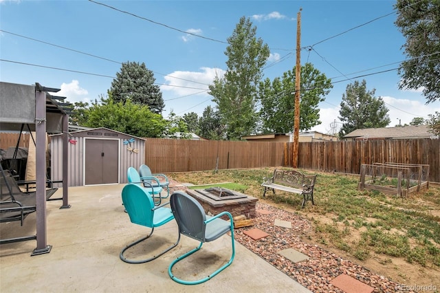 view of patio / terrace with a storage shed and an outdoor fire pit