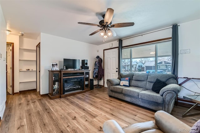 7940 Pontiac St, Commerce City, CO 80022 - living room with ceiling fan, baseboards, and light wood-style floors