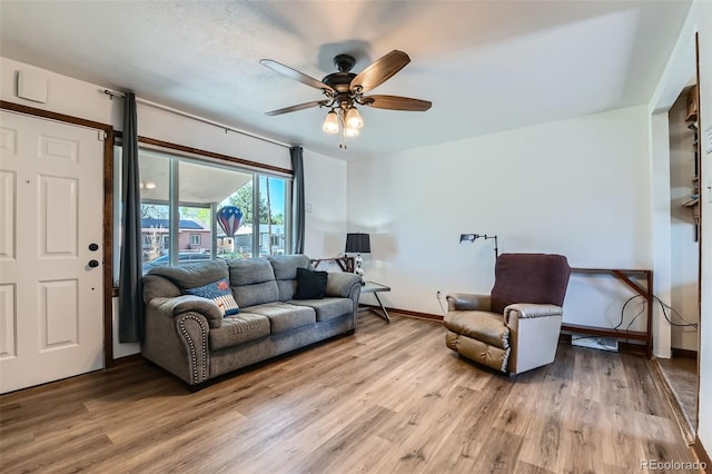 7940 Pontiac St, Commerce City, CO 80022 - living room with light wood finished floors, baseboards, and a ceiling fan