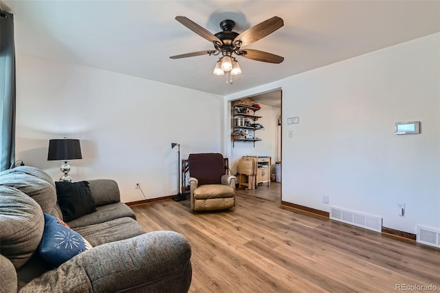 7940 Pontiac St, Commerce City, CO 80022 - living area featuring ceiling fan, baseboards, light wood-style floors, and visible vents