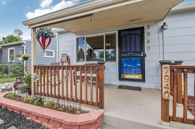 7940 Pontiac St, Commerce City, CO 80022 - view of exterior entry with a porch and fence