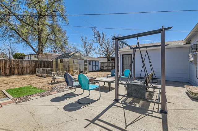7940 Pontiac St, Commerce City, CO 80022 - view of patio / terrace featuring an outdoor structure, an exterior structure, and a fenced backyard
