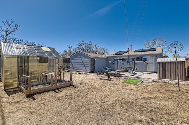 7940 Pontiac St, Commerce City, CO 80022 - view of yard with a fire pit, an outbuilding, a shed, and an exterior structure