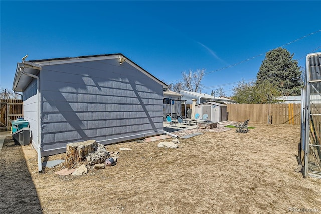7940 Pontiac St, Commerce City, CO 80022 - view of side of property featuring a fenced backyard, a storage unit, and an outdoor structure