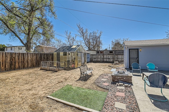 7940 Pontiac St, Commerce City, CO 80022 - view of yard with an exterior structure, an outbuilding, a fenced backyard, and a fire pit