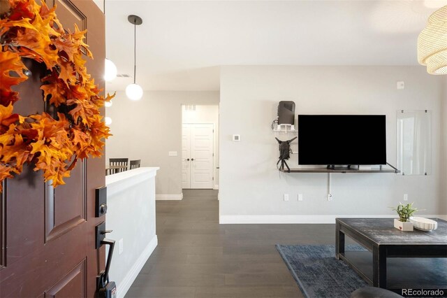 1831 S Dunkirk St Unit 103, Aurora, CO 80017 - foyer featuring baseboards and dark wood finished floors