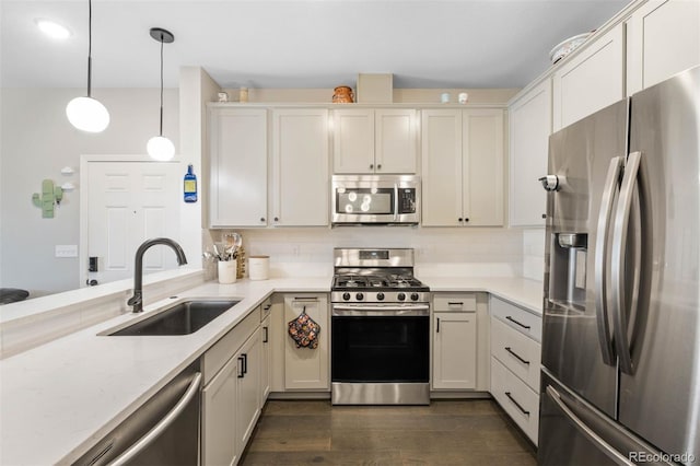 1831 S Dunkirk St Unit 103, Aurora, CO 80017 - kitchen with appliances with stainless steel finishes, pendant lighting, dark wood-style flooring, and white cabinetry