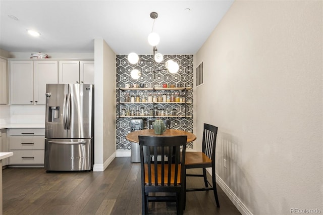 1831 S Dunkirk St Unit 103, Aurora, CO 80017 - dining space with dark wood-style floors and an accent wall
