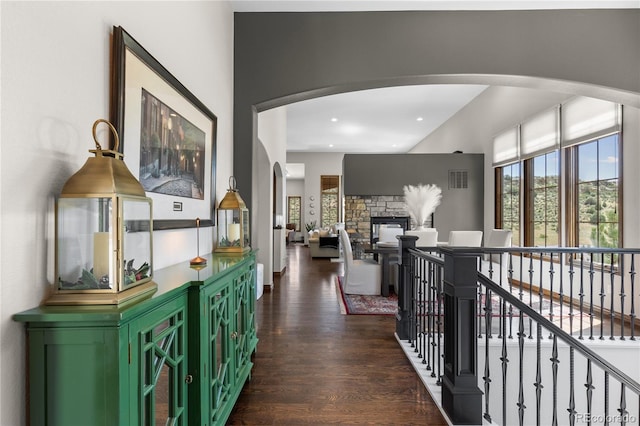 8000 Raphael Ln, Littleton, CO 80125 - hall featuring healthy amount of natural light, dark wood-style flooring, arched walkways, and recessed lighting