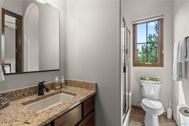 8000 Raphael Ln, Littleton, CO 80125 - bathroom featuring vanity, a stall shower, tile patterned floors, and a textured wall