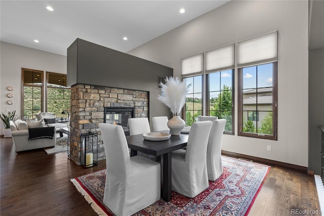 8000 Raphael Ln, Littleton, CO 80125 - dining room with a fireplace, wood finished floors, and recessed lighting