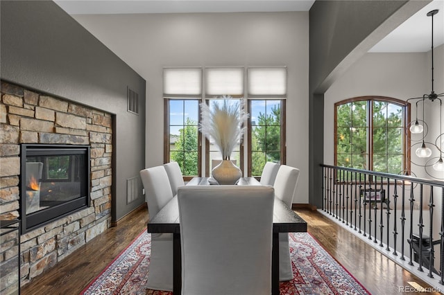 8000 Raphael Ln, Littleton, CO 80125 - dining area featuring wood finished floors, healthy amount of natural light, and a fireplace