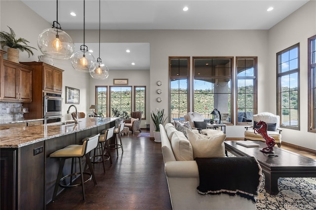 8000 Raphael Ln, Littleton, CO 80125 - living area with recessed lighting and dark wood finished floors