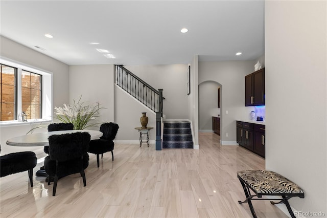 8000 Raphael Ln, Littleton, CO 80125 - dining room with arched walkways, stairs, recessed lighting, and light wood-type flooring