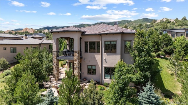 8000 Raphael Ln, Littleton, CO 80125 - view of front facade with a balcony, stucco siding, a mountain view, and a tile roof