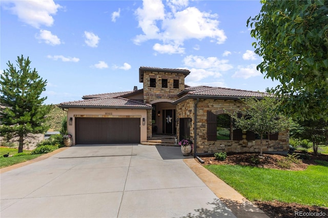 8000 Raphael Ln, Littleton, CO 80125 - mediterranean / spanish house featuring stone siding, a tiled roof, a garage, driveway, and stucco siding