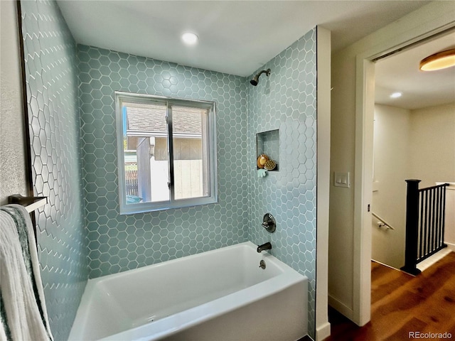 bathroom with wood-type flooring and tiled shower / bath