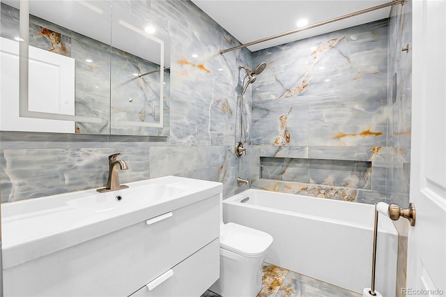 full bath featuring toilet, shower / tub combination, vanity, and tile walls